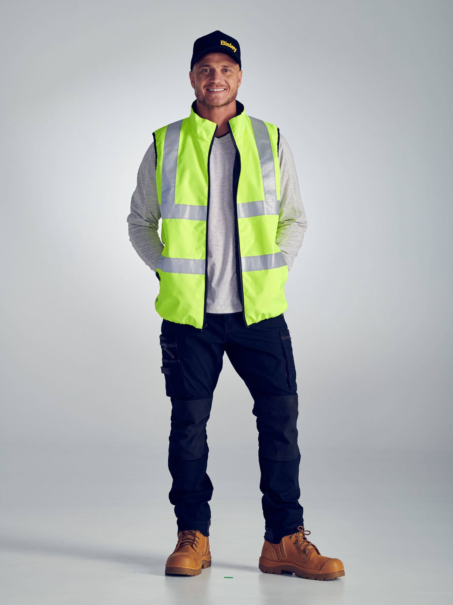 Mens Reversible Puffer Vest with H-pattern reflective tape and custom corporate logo